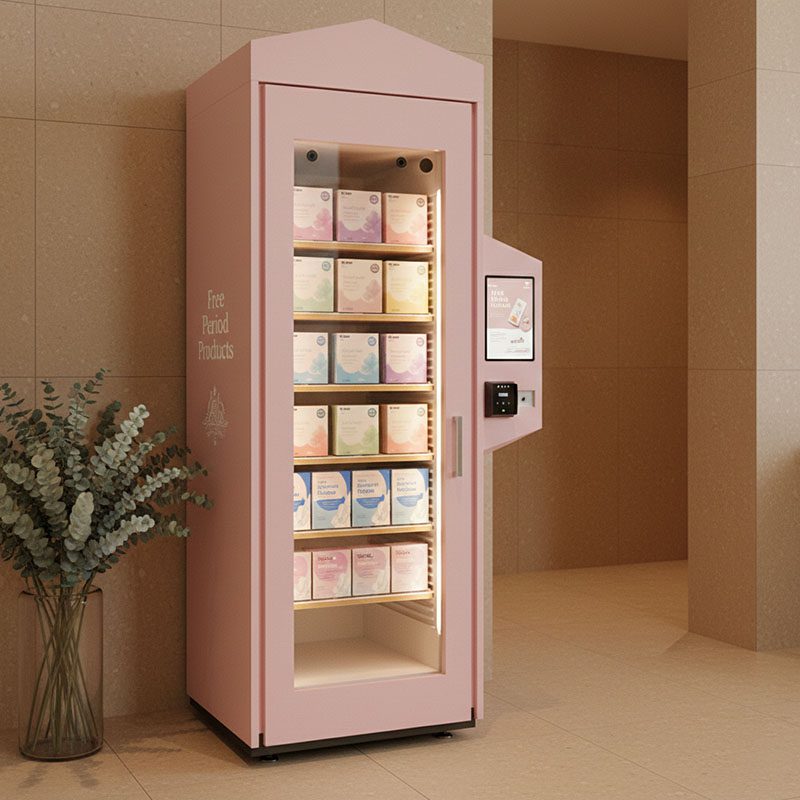 A uniquely designed pink smart open-door vending cabinet by Reyeah, featuring a touchscreen interface for the free distribution of women's health and hygiene supplies