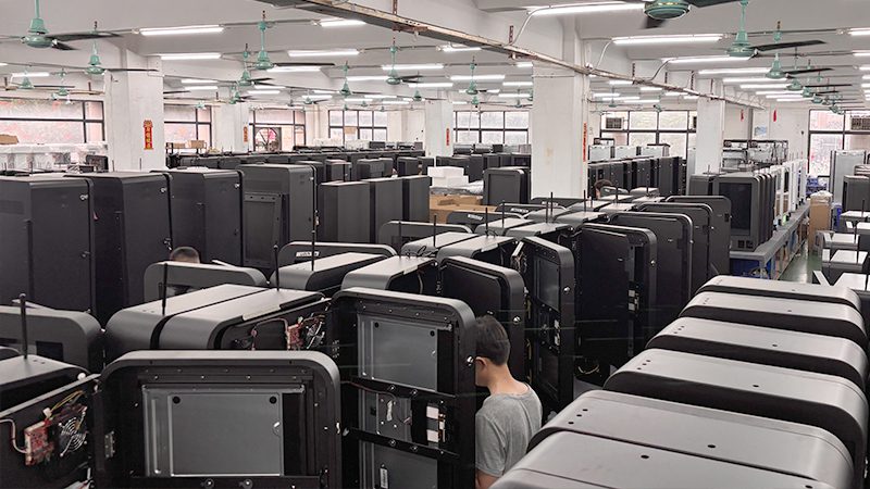 Technicians assembling smart vending machines at the Reyeah factory