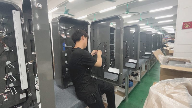 Technicians assembling smart vending machines at the Reyeah factory